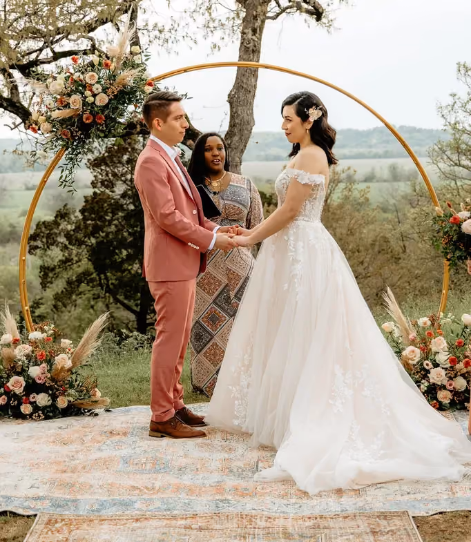 A floral arch featuring Poppy’s Golden Canyon color palette for summer