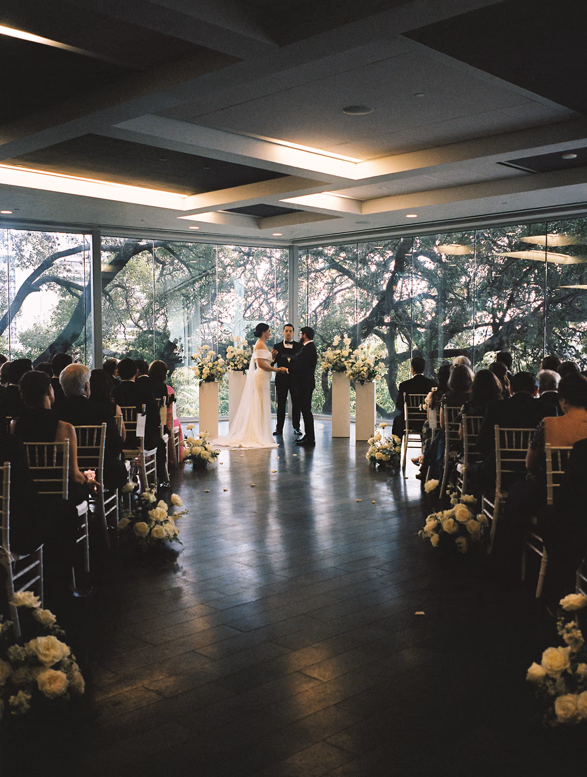 Ceremony floral backdrop with white blooms and greenery
