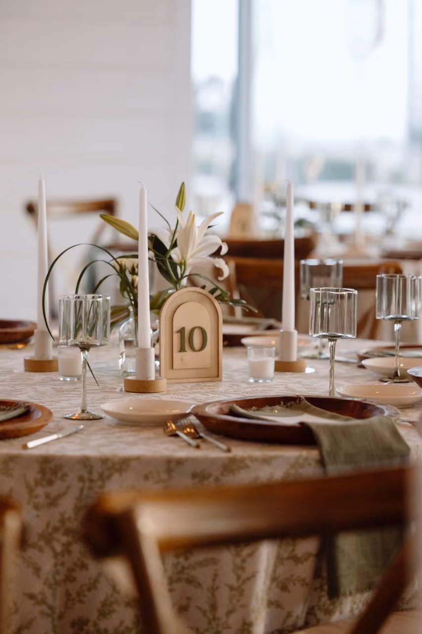 Loose tropical greenery table vases with lime accents for modern beach wedding