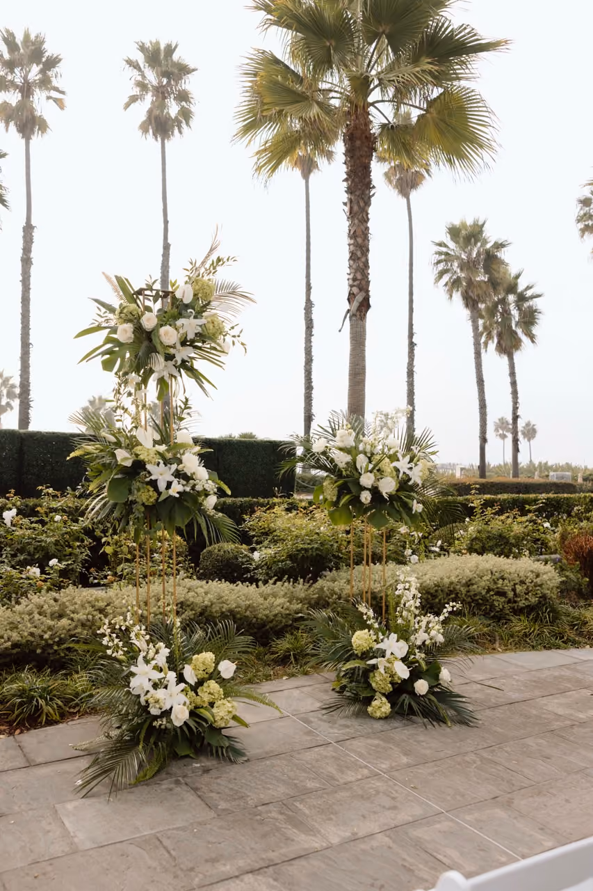 Deconstructed wedding arch with lime green hydrangeas and white flowers at oceanside ceremony