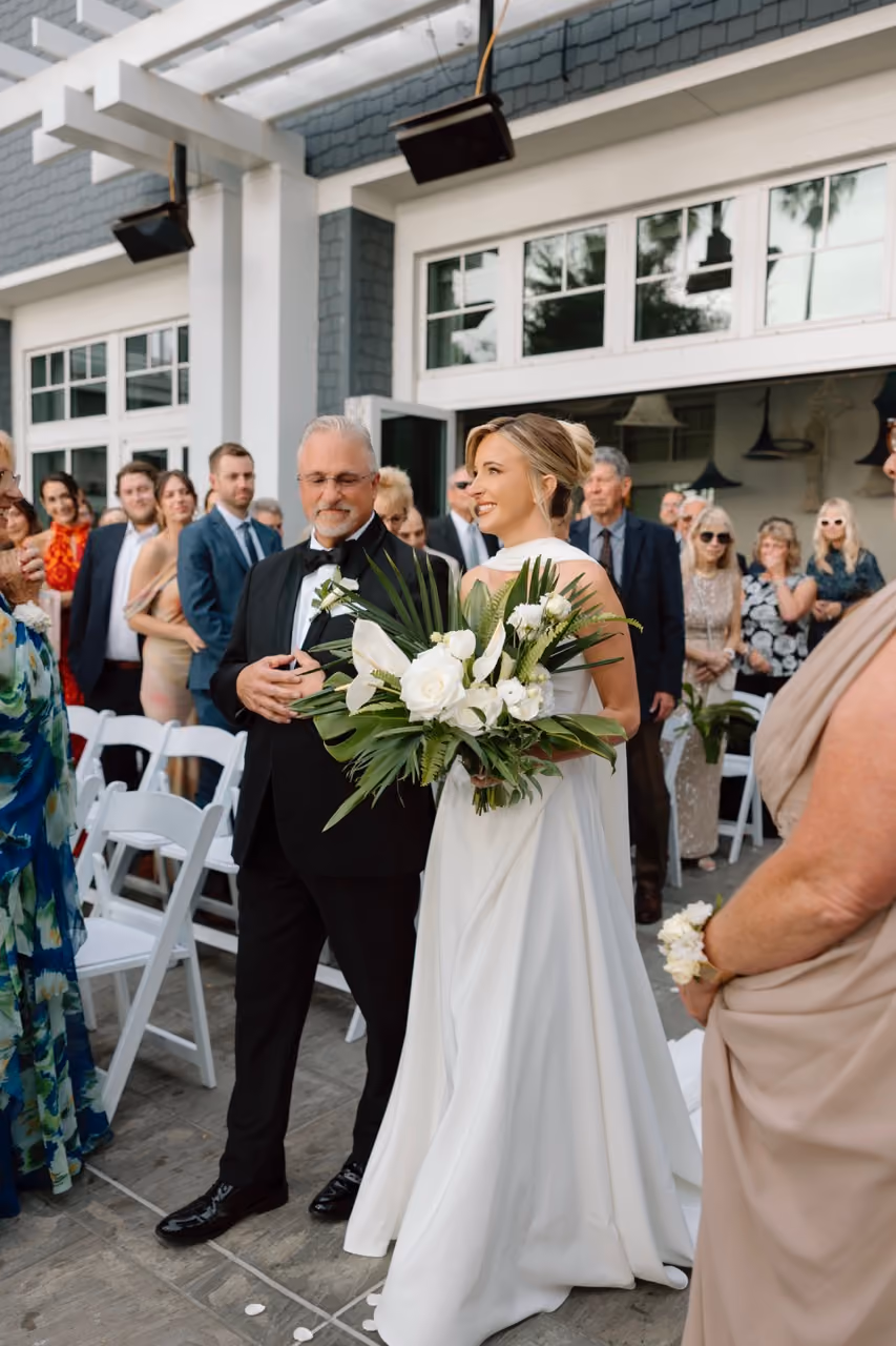 Bride and groom with modern tropical wedding bouquet at Oceanside beach wedding