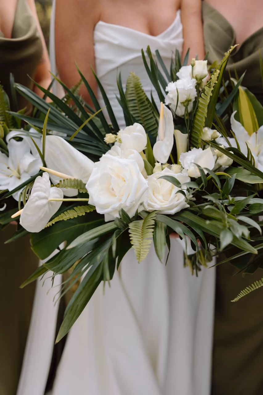 White anthurium and calla lily bridal bouquet with palm fronds for modern tropical Oceanside wedding