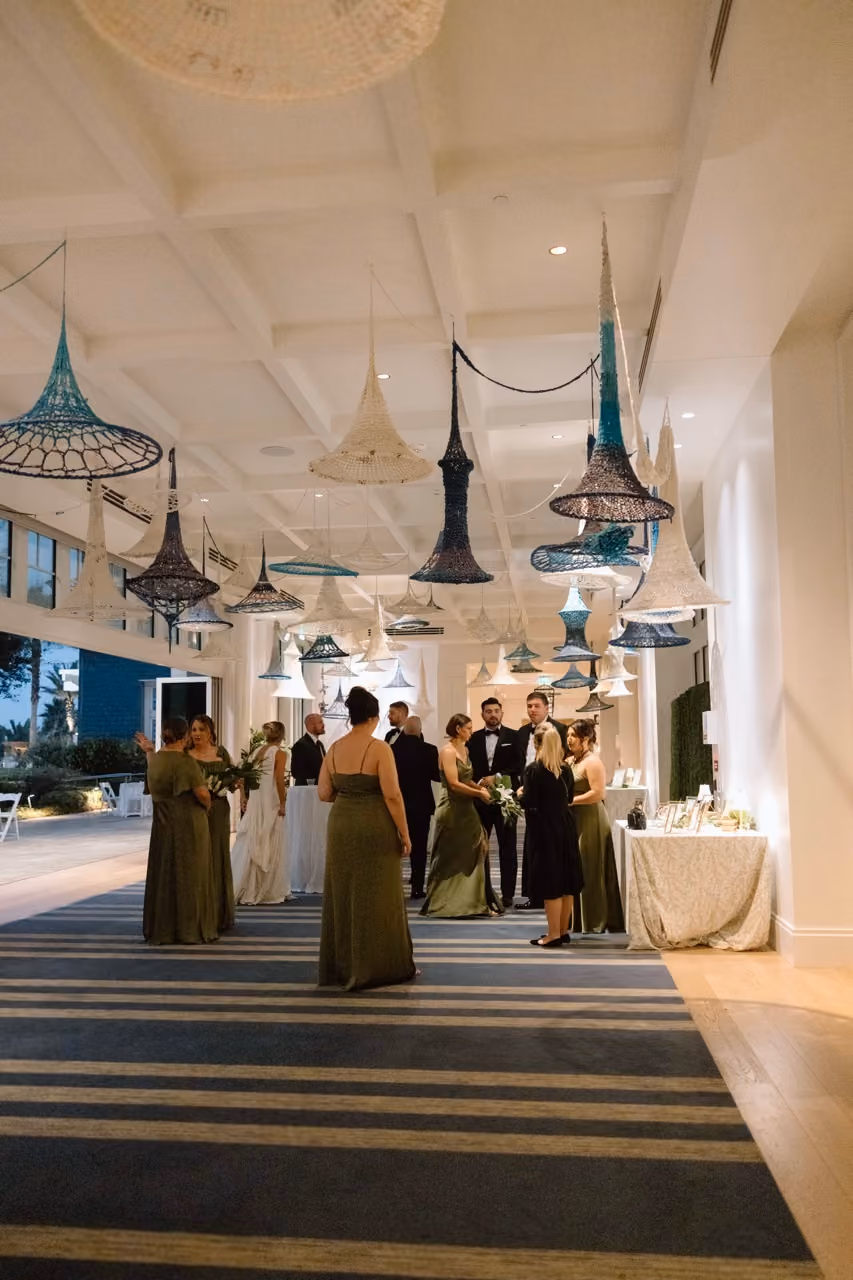 The Seabird Ocean Resort terrace wedding ceremony with tropical floral arch overlooking Pacific
