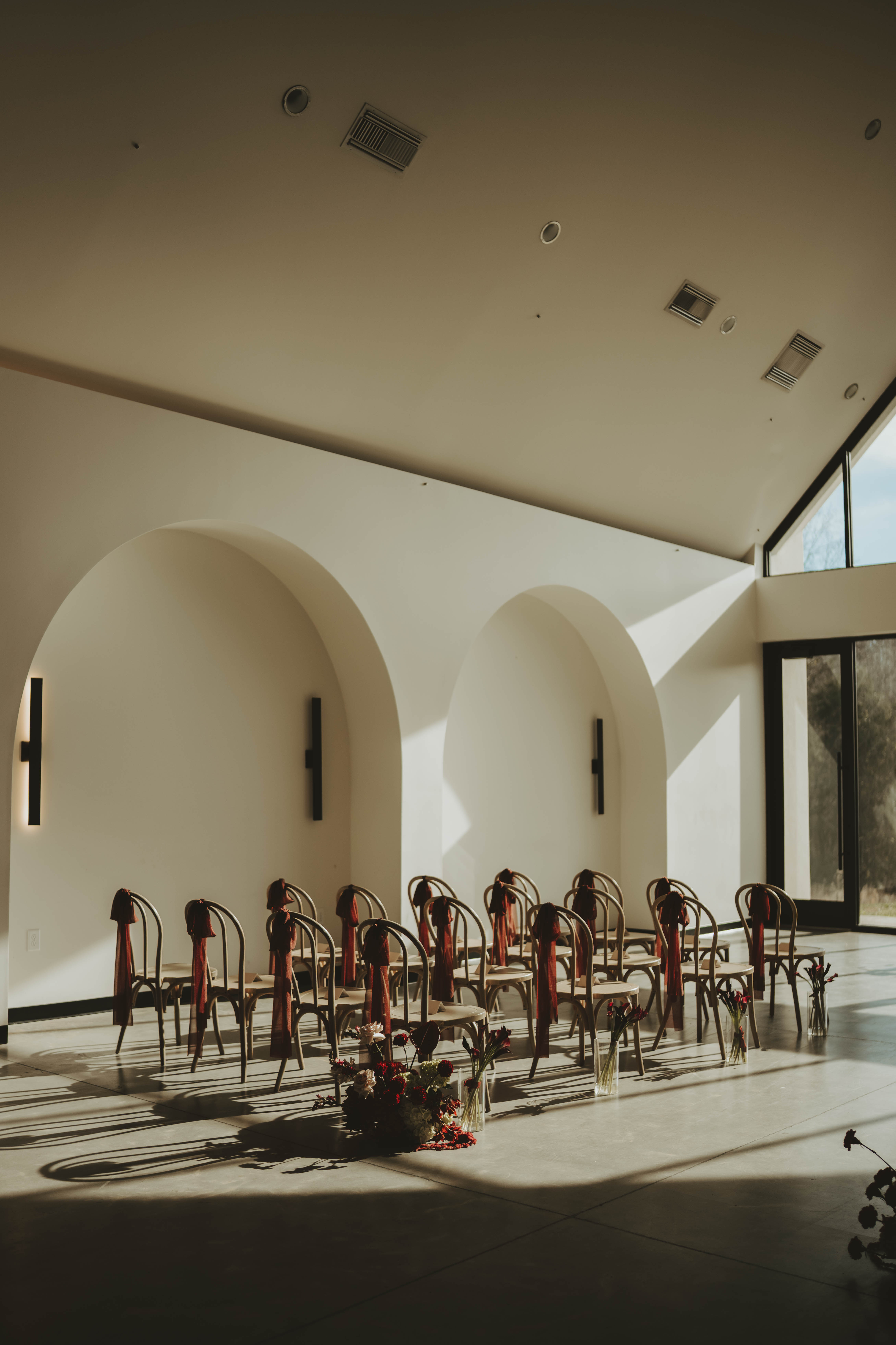 Full wedding floral setup at The Lumen House featuring moody burgundy and deep red flowers