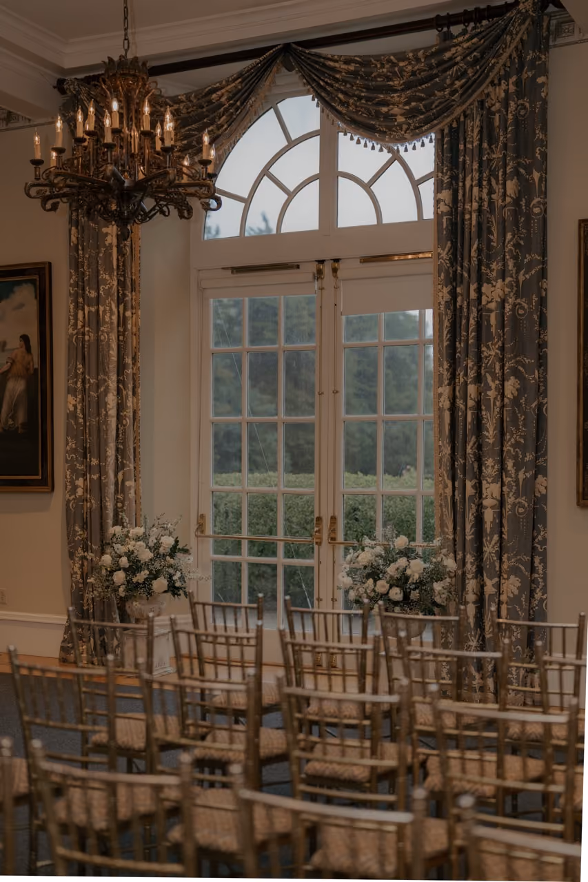 Indoor wedding ceremony at Wadsworth Mansion with blue carpet and ornate architecture