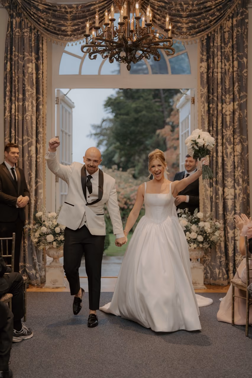 Bride walking down aisle at Wadsworth Mansion rainy day wedding