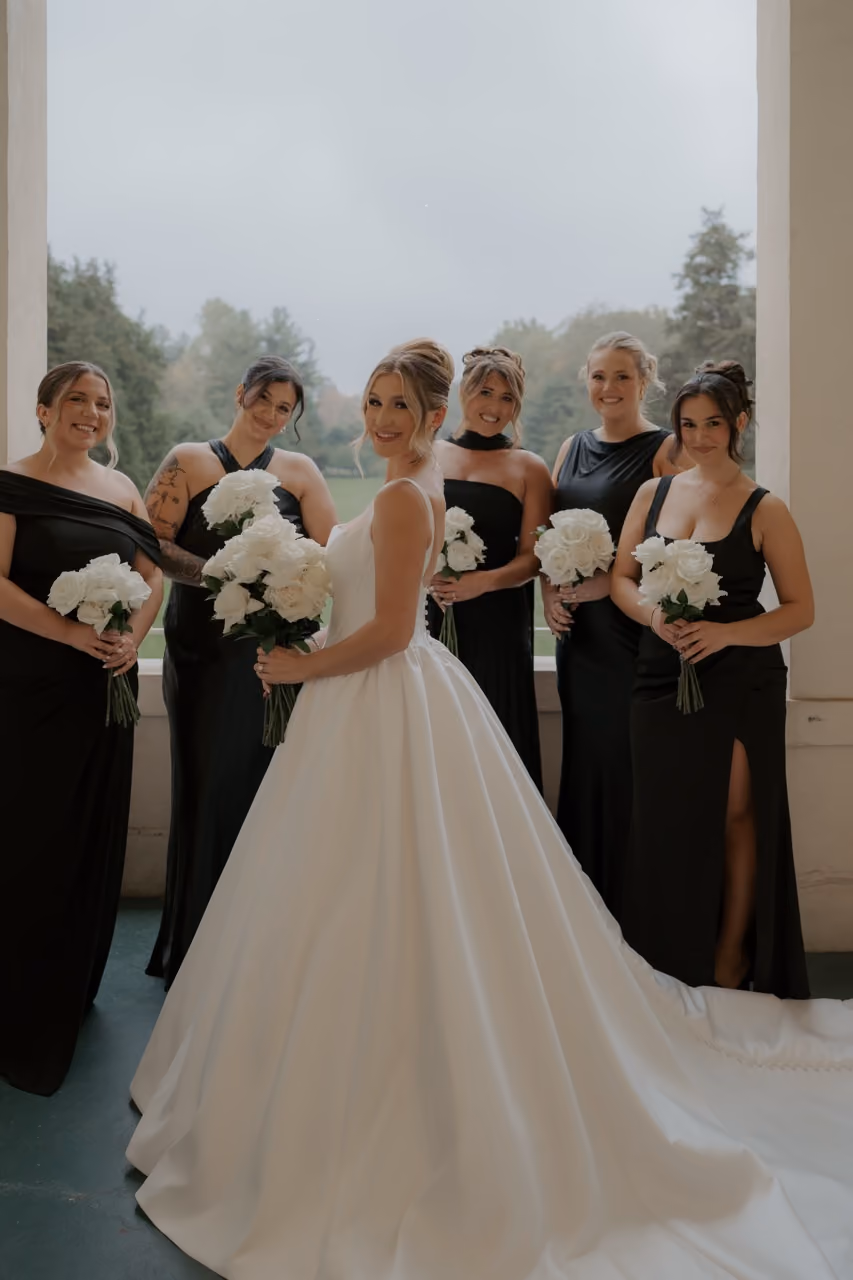 Elegant white wedding bouquet against black bridesmaids dresses