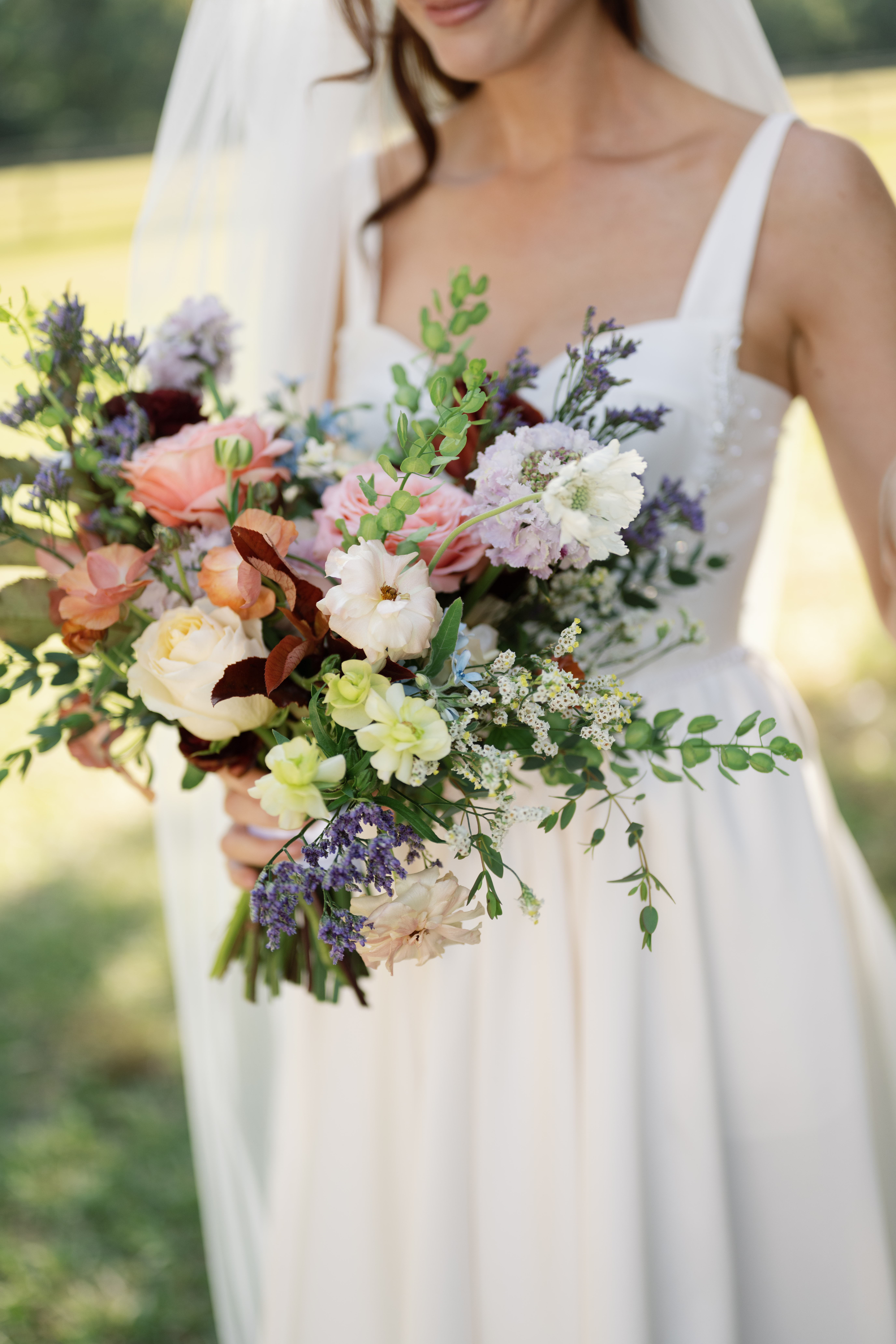 lush bridal bouquet in warm colors for mid-range wedding budget
