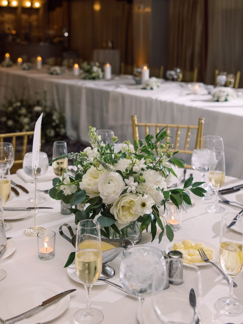 modern white reception table with luxury florals at mid-range price